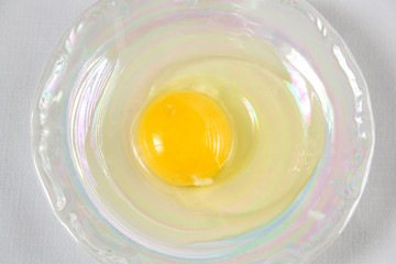 raw egg on a mother of pearl plate