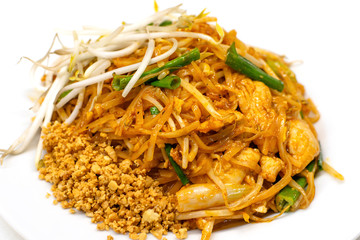 Dish of Pad thai on white background.Pad thai or phad thai, is a stir-fried rice noodle dish commonly served as a street food and at most restaurants in Thailand as part of the country's cuisine.