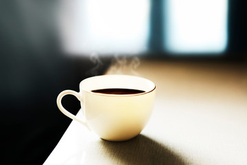 Cup of coffee and smoke by the window