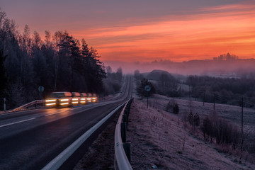 Dramatic sunrise by the road with hoarfrost