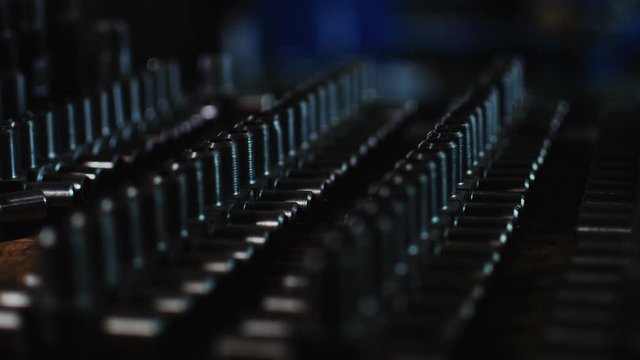 rows of new t-shaped pipe joints on wooden desk in shop