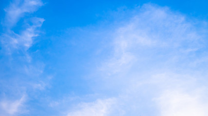 A blue sky with beautiful wisp of cloud for use as a backing or backdrop.