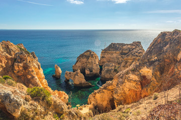 Turquoise sea bay among rocks and cliffs at Ponta da Piedade near Lagos, Algarve region, Portugal