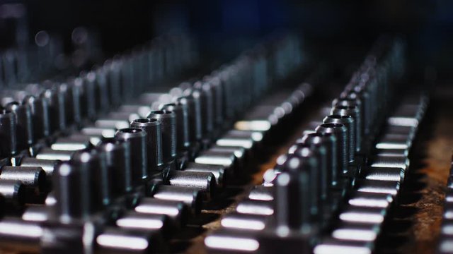 motion past set of metal t-shaped pipe valves on table
