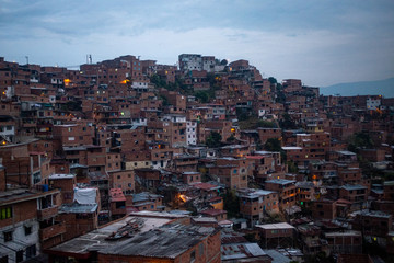 Fototapeta na wymiar Medellin, Antioquia /Colombia - January 20 2020: Dark Brick Houses in the Steep Hills of the Valley at Night
