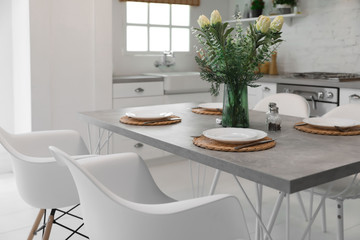 Elegant table setting in stylish kitchen. Interior design