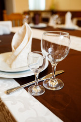 Table setting in a restaurant. Glass, plate, fork, knife
