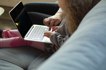 Happy loving family. Grandmother and grandchild spending time together. Watching cinema, using laptop, laughting. Mother's day, celebration, weekend, holiday and childhood concept. Close up of hands.