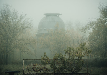 observatory and telescope in the morning fog