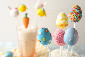 Egg shaped cake pops on light background, space for text. Easter celebration