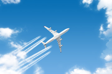 Fototapeta na wymiar modern airplane flying high above clouds landscape against blue sky background. Aerial top down view of aircraft. White passenger plane belly. AIr travel by commercial jet airliner. Aviation wallpaper