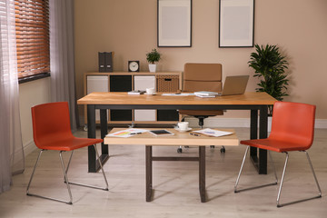 Fototapeta na wymiar Director's office with large wooden table. Interior design