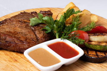 grilled beef with cherry tomatoes with sauces, parsley
