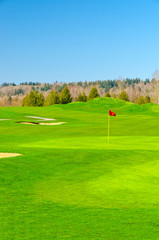Obraz premium Golf place with gorgeous green and sand bunker.