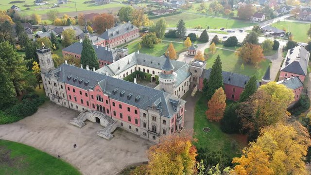Scenic aerial view of historical neo-gothic Sychrov castle with colorful fall park, Czech Republic