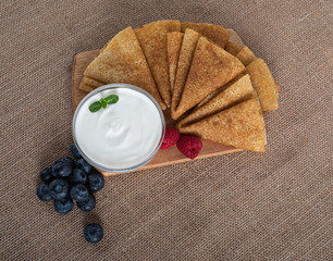 pancakes with berries and on a wooden Board