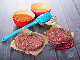 Burger cutlet on craft paper with pepper and spices