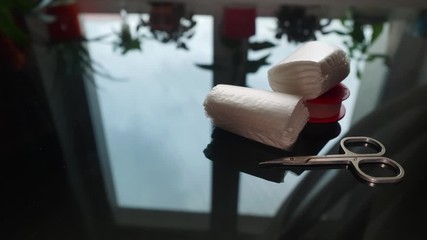 Panorama of medical napkins, scissors for gauze bandages on black mirror table