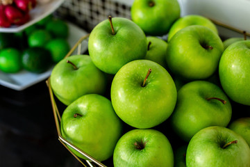 Green Apples and vegetable garden on the basket On the table to the kitchen