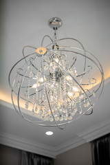 Fototapeta na wymiar Warm light chandelier on the ceiling of the room