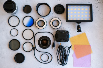 Flat lay composition with equipment for professional photographer on grey background.