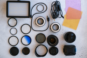 Flat lay composition with equipment for professional photographer on grey background.