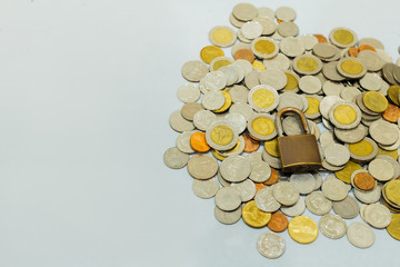 Coin money and lock, on gray background. Saving and financial security concept.