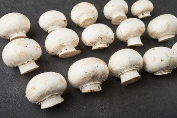 Fresh champignon mushrooms on wooden table, closeup. Space for text