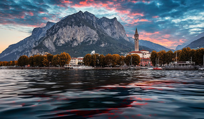 Wonderful sunset over the Lecco town. Italy, Europe. Fantastic summer sunrise on Como lake with colorful dramatic sky. Amazing nature scenery. Best popular places for travel. landscape cityscape view - obrazy, fototapety, plakaty