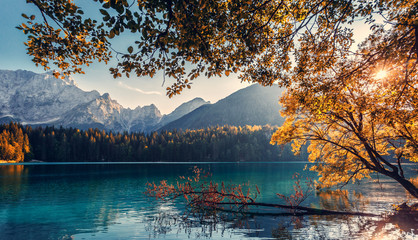 Impressively beautiful Fairy-tale mountain lake in Julian Alps. Breathtaking summer Scene. Panoramic view of beautiful mountain landscape in Alps with Fusine Lake with Mangart Mount on background.