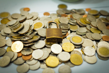 Coin money and lock, on gray background. Saving and financial security concept.