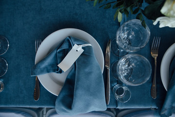 wedding table decor with blue tablecloth and glasses in restaurant