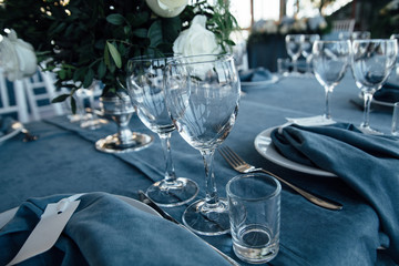 wedding table decor with blue tablecloth and glasses in restaurant