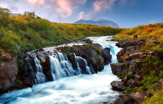 Wonderful nature landscape. Scenik image of Iceland. Fairy tale Waterfal and Majestic mount on background during sunset. Beauty in the world. Amazing natural background. Creative image. © jenyateua
