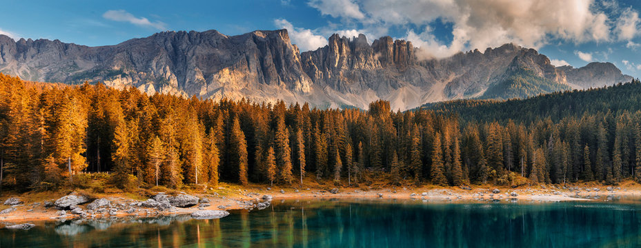 Awesome alpine highlands with dramatic sky. Scenic image of fairy-tale Landscape in Dolomites alps. incredible view majestic Dolomite alps with reflection on Lake Karersee, Lago di Carezza. panorama