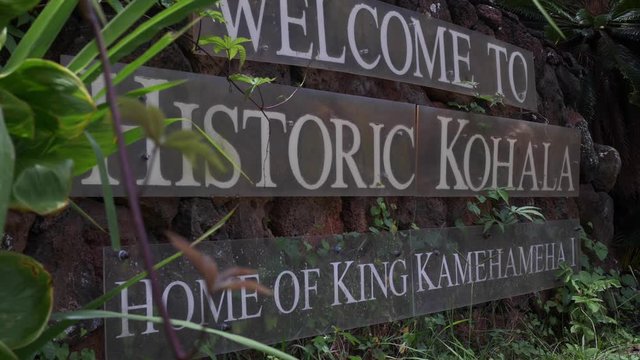 Pan left, road sign for Kohala historic site in Hawaii