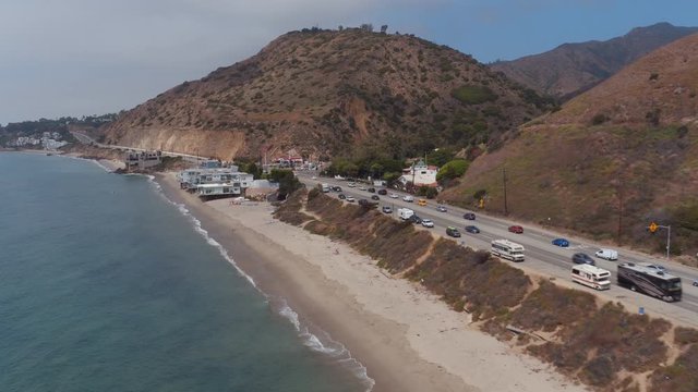 Aerial, cars drive down PCH in Malibu