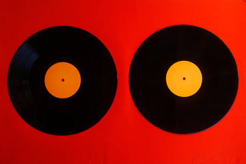 Vinyl record on a red background. Retro style. Top view.