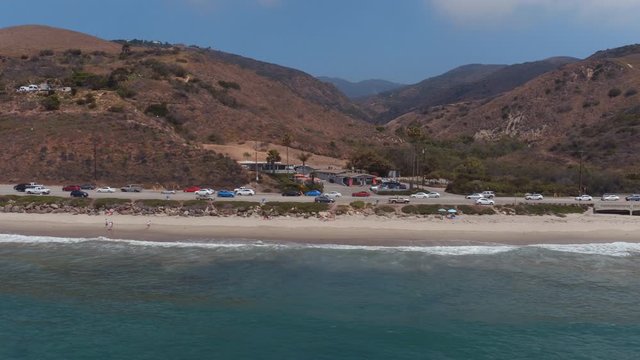 PCH traffic along Malibu coastline, panning aerial