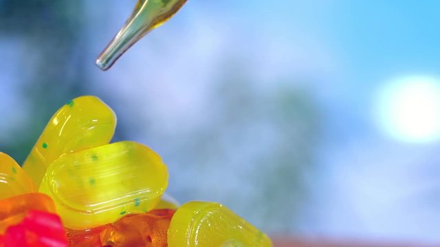 CBD oil drops of oil with a pipette candy lollipops with Kanabis, on a blue background.