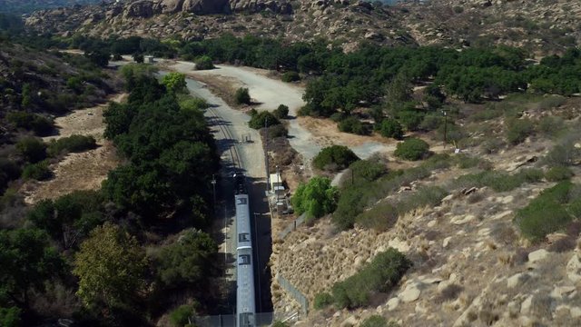 Train drives through Simi Valley mountains, aerial