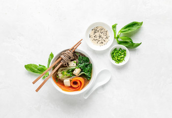 Bok choy and tofu vegetarian udon noodles soup, top down view