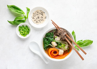 Bok choy and tofu vegetarian udon noodles soup, top down view