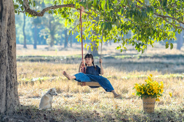 Rural girl Playing swing with her dog