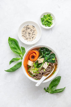 Bok choy and tofu vegetarian udon noodles soup, top down view