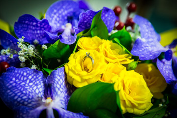  Wedding ring lying in a bouquet of delicate flowers