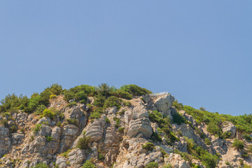 Mountains and rocks on the beach in summer on a Sunny day