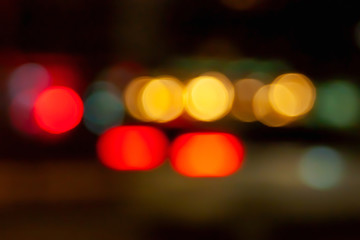 Blurred light of car headlights. Blurred image of the light of street lamps and car headlights at night riding in the city. Bokeh elements.