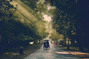 sun rays at sunset in angkor wat with tuk tuk backlit