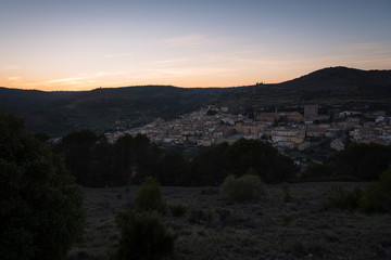 A top view of the medieval village of Pastrana surrounded by mountains at sunset, Guadalajara, Spain
